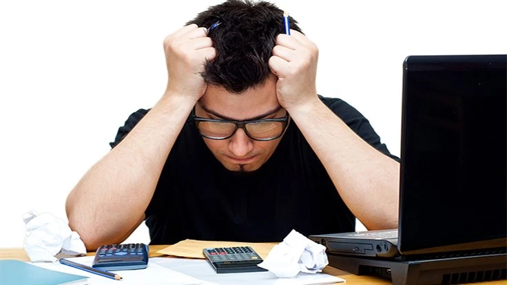 Distressed man looking at phone