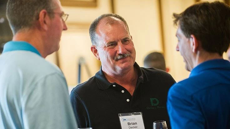 Brian Decker chats with colleagues at an industry event.