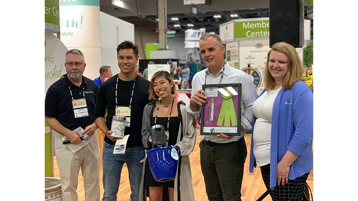 The team from CTI Plastics Plastic Pots shows off their award-winning pots made from recycled plastic from the sea