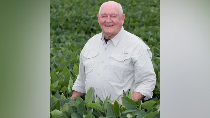 A smiling man in a field