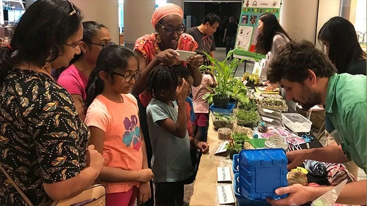 Families take part in a pre-pandemic Plant Biology for Kids museum event