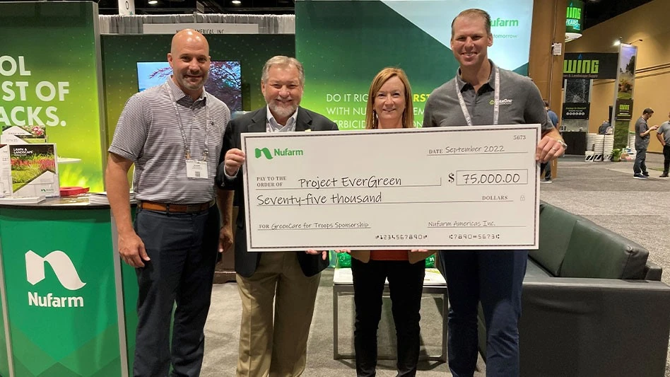 Nufarm’s Blaine Pinkerton (left) presents the check for its sponsorship of the GreenCare for Troops program to Project EverGreen Treasurer Fred Haskett (second from left), Executive Director Cindy Code (middle) and Board President Kevin Laycock (right).