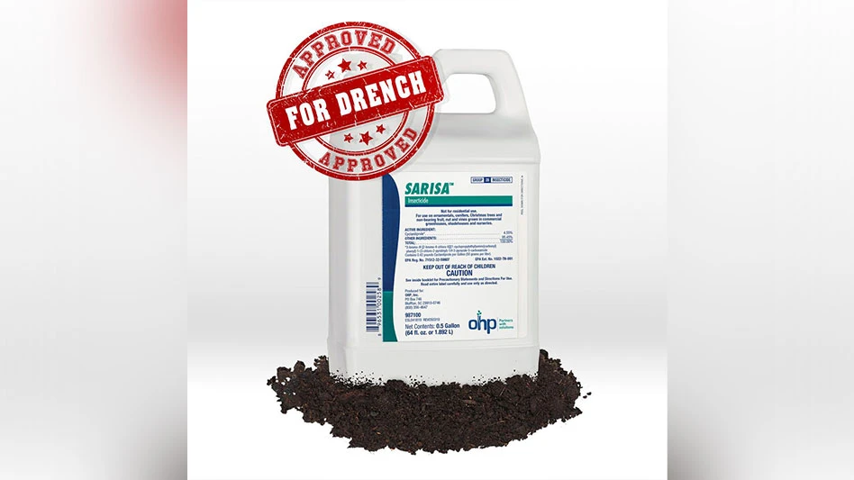 A white jug of Sarisa insecticide sitting in a pile of brown soil. The label is white with blue and teal text and coloring, and there's a red stamp over the image that reads Approved for Drench.