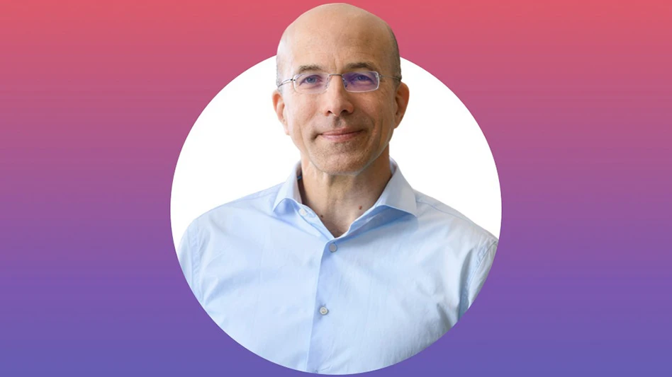 A headshot photo of a bald man wearing glasses and a light blue dress shirt. The background of the photo is white, and the background of the rest of the image is a gradient pink to blue.