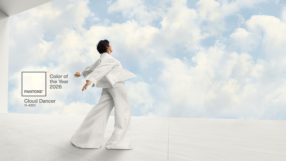 A man wearing a flowing white robe has his arms outstretched behind him in front of a blue sky with white clouds.