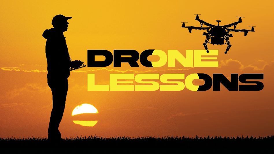 A silhouette of a man flying a drone in the sunset.