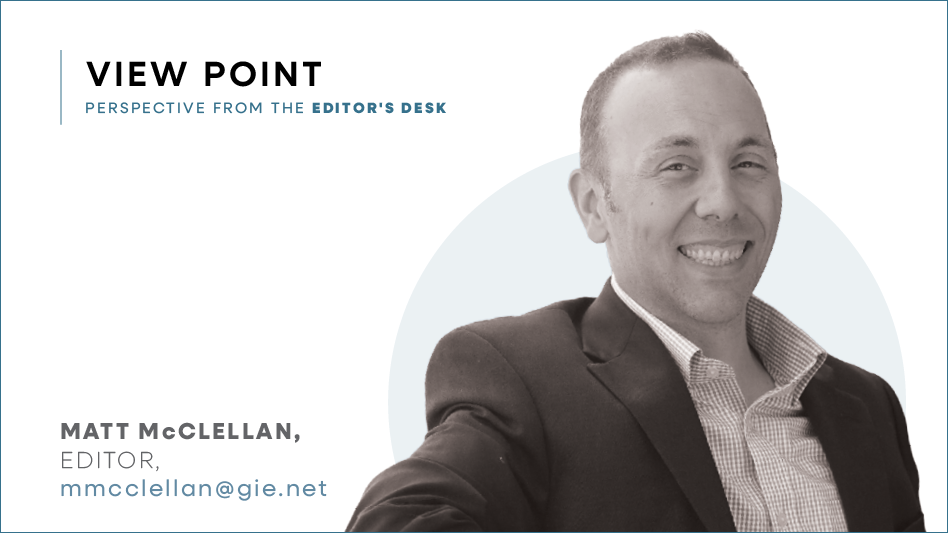 Black and white headshot of a man wearing a suit.